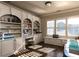 Inviting home office with custom built-ins, lots of shelving and storage, hardwood floors, and a window seat at 3053 Cambridge Hill Dr, Dacula, GA 30019