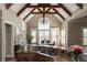 Kitchen with large window, wooden beams, granite counters and a view to dining area at 3053 Cambridge Hill Dr, Dacula, GA 30019