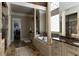 Luxury bathroom boasts a soaking tub, dual vanities, columns, and a walk-in closet at 3053 Cambridge Hill Dr, Dacula, GA 30019