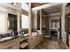 Elegant primary bathroom featuring a soaking tub, decorative columns, and custom vanities at 3053 Cambridge Hill Dr, Dacula, GA 30019