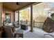 Covered porch with fireplace, ceiling fan, and comfortable seating with a wooded view at 3053 Cambridge Hill Dr, Dacula, GA 30019