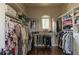 Spacious walk-in closet with custom shelving, hanging rods, hardwood floors, and a window for natural light at 3053 Cambridge Hill Dr, Dacula, GA 30019