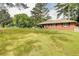 A single-story home with a big grassy front yard and surrounded by mature trees at 3221 Colquitt Dr, Atlanta, GA 30340