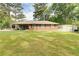 Single-story brick home with black shutters and a large grassy front yard and a detached garage at 3221 Colquitt Dr, Atlanta, GA 30340