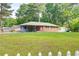 A single-story home with a spacious front yard, shed, and a charming white picket fence at 3221 Colquitt Dr, Atlanta, GA 30340