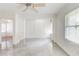 Bright living room featuring windows, a ceiling fan, and sleek, tiled flooring at 3221 Colquitt Dr, Atlanta, GA 30340