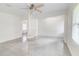Bright living room with tile floors, white walls, a ceiling fan, and built-in shelves for versatile design at 3221 Colquitt Dr, Atlanta, GA 30340