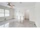Light-filled living room featuring sleek tile floors, built-in shelving and a ceiling fan at 3221 Colquitt Dr, Atlanta, GA 30340