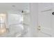 Bright living room featuring tile floors, a ceiling fan, built-in shelves, and a fresh, minimalist design at 3221 Colquitt Dr, Atlanta, GA 30340