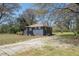 Exterior angle showing gravel driveway and side view of charming home at 5085 Lake Dr, Forest Park, GA 30297