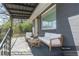 Virtually staged front porch with seating, inviting outdoor relaxation at 5085 Lake Dr, Forest Park, GA 30297