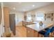 Modern kitchen with stainless steel appliances, white counters and bar seating at 5085 Lake Dr, Forest Park, GA 30297