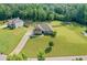 Expansive aerial view of a home with a large lawn, long driveway, and surrounded by lush greenery at 1246 Foxcreek Dr, Mcdonough, GA 30252