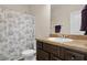 Cozy bathroom with a shower, commode, and granite vanity at 1246 Foxcreek Dr, Mcdonough, GA 30252