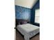 Bedroom featuring a modern design with blue walls, silver accents, and sleek, minimalist furniture at 1246 Foxcreek Dr, Mcdonough, GA 30252