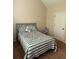 Bedroom features a neutral color, vaulted ceiling, and window providing natural light at 1246 Foxcreek Dr, Mcdonough, GA 30252