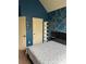 Cozy bedroom with blue walls, and decorative shelving at 1246 Foxcreek Dr, Mcdonough, GA 30252