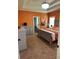 Bedroom featuring orange walls, gray furniture, and unique overhead hanging chair at 1246 Foxcreek Dr, Mcdonough, GA 30252