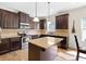 Well-appointed kitchen with dark wood cabinetry, granite countertops, stainless steel appliances, and a central island at 1246 Foxcreek Dr, Mcdonough, GA 30252