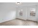 Bright bedroom with hardwood floors and two windows offering lots of natural light at 2528 Morgan Chase Dr, Buford, GA 30519