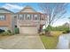 Charming two-story home featuring a brick facade, attached garage, and well-manicured landscaping at 2528 Morgan Chase Dr, Buford, GA 30519