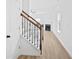 Bright stairway with wood railing, iron balusters and light hardwood flooring at 2528 Morgan Chase Dr, Buford, GA 30519