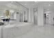 Elegant bathroom featuring marble finishes, a soaking tub, walk-in shower, and a glimpse of the walk-in closet at 2828 Peachtree Nw Rd # 3100, Atlanta, GA 30305