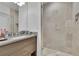 Modern bathroom featuring a sleek vanity with drawers, a glass-enclosed shower, and neutral tile at 2828 Peachtree Nw Rd # 3100, Atlanta, GA 30305