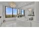 Luxury bathroom showcasing a soaking tub, large windows with a view, and elegant marble finishes at 2828 Peachtree Nw Rd # 3100, Atlanta, GA 30305