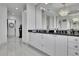Modern bathroom vanity area with dual sinks, sleek white cabinetry, and elegant mirrors at 2828 Peachtree Nw Rd # 3100, Atlanta, GA 30305