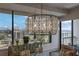 Bright dining area featuring a modern chandelier, seating for six, and floor to ceiling windows with a city view at 2828 Peachtree Nw Rd # 3100, Atlanta, GA 30305