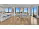 Bright dining area featuring a modern chandelier, seating for six, and floor to ceiling windows with a city view at 2828 Peachtree Nw Rd # 3100, Atlanta, GA 30305