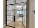 Elegant entryway with steel and glass doors leading to a formal living room with stunning chandelier at 2828 Peachtree Nw Rd # 3100, Atlanta, GA 30305
