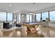 Bright game room boasts hardwood floors, a modern pool table, stylish furnishings, and city views through expansive windows at 2828 Peachtree Nw Rd # 3100, Atlanta, GA 30305