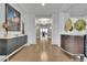 Long hallway with hardwood floors leading to a room with chandelier and featuring art pieces at 2828 Peachtree Nw Rd # 3100, Atlanta, GA 30305