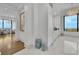 Hallway leading to a modern bathroom and bright sitting room with floor to ceiling windows and city views at 2828 Peachtree Nw Rd # 3100, Atlanta, GA 30305