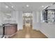 Bright hallway with hardwood floors, mirrored walls, chandelier lighting, and a full bar setup at 2828 Peachtree Nw Rd # 3100, Atlanta, GA 30305