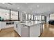Modern kitchen features white cabinets, marble countertops, stainless steel appliances, and an island with bar seating at 2828 Peachtree Nw Rd # 3100, Atlanta, GA 30305