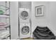 Functional laundry area featuring stacked washer and dryer units and shelving at 2828 Peachtree Nw Rd # 3100, Atlanta, GA 30305