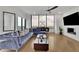 Spacious living room featuring comfortable seating, a modern fireplace, and floor to ceiling windows with a city view at 2828 Peachtree Nw Rd # 3100, Atlanta, GA 30305