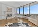 Bright living room featuring a white baby grand piano, fireplace, and panoramic city views at 2828 Peachtree Nw Rd # 3100, Atlanta, GA 30305