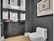 Stylish powder room boasts dark wallpaper, mirrored accents, modern fixtures, and a classic toilet at 2828 Peachtree Nw Rd # 3100, Atlanta, GA 30305