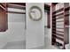 Spacious walk-in closet features custom shelving, hanging rods, and a stylish round mirror on the wall at 2828 Peachtree Nw Rd # 3100, Atlanta, GA 30305