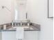 Bright powder room featuring a modern gray countertop, sleek faucet, and decorative accents at 379 Pratt Se Dr # 408, Atlanta, GA 30315