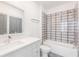 Bathroom with modern vanity, gray tiled floors, tub, and tiled walls at 379 Pratt Se Dr # 408, Atlanta, GA 30315