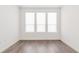 Bright bedroom featuring hardwood floors, three large windows, and white walls at 379 Pratt Se Dr # 408, Atlanta, GA 30315