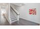 Bright entryway with hardwood floors, white walls, staircase, and artistic decor create a welcoming ambiance at 379 Pratt Se Dr # 408, Atlanta, GA 30315