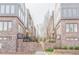Close-up of townhome exteriors with brick facade, stairs, and green landscaping at 379 Pratt Se Dr # 408, Atlanta, GA 30315