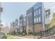 Modern townhome exterior featuring brick accents, large windows, and private balconies at 379 Pratt Se Dr # 408, Atlanta, GA 30315