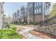 Attractive townhome exteriors with brick and siding, enhanced by well-kept landscaping and appealing staircases at 379 Pratt Se Dr # 408, Atlanta, GA 30315